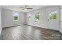 Bright living room with sleek floors, large windows, and a modern ceiling fan at 410 E 17Th St, Kannapolis, NC 28083