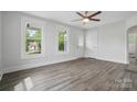 Bright living room with sleek floors, large windows, and a modern ceiling fan at 410 E 17Th St, Kannapolis, NC 28083