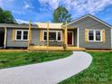 Charming one-story home with a welcoming front porch and a freshly painted walkway at 501 N Hawthorne St, Mount Holly, NC 28120