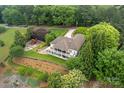 An aerial view of a beautiful home with lush green lawns, trees, and lake access at 7471 Barfield Ln, Denver, NC 28037