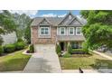 Charming two-story home with a manicured lawn and a two-car garage at 8200 Sunset Hill Rd, Waxhaw, NC 28173