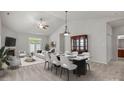 Bright dining room features a marble table, modern decor, and is open to the living room, great for entertaining at 8313 Carob Tree Ln, Charlotte, NC 28215