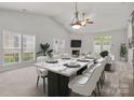 Bright dining room features a fireplace, large windows, and a spacious layout, perfect for gathering and entertaining guests at 8313 Carob Tree Ln, Charlotte, NC 28215