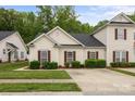 Attractive home with beige siding, red shutters, and neatly trimmed front yard landscaping at 8313 Carob Tree Ln, Charlotte, NC 28215