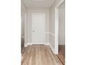 Inviting entryway with wood-look floors and white trim at 8325 Knights Bridge Rd, Charlotte, NC 28210