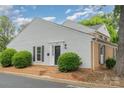 Charming exterior with white siding, brick foundation, and neat landscaping at 8325 Knights Bridge Rd, Charlotte, NC 28210