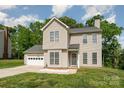 Charming two-story home featuring a two-car garage, well-kept lawn, and many windows for great light at 8509 Sienna Dr, Charlotte, NC 28215