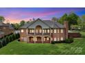 Back of a two-story brick house with a large yard and multiple covered patios at 89 Wexford Pt, Hickory, NC 28601