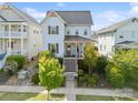 Charming blue two-story home with landscaped front yard and inviting front porch on a sunny day at 962 Herrons Ferry Rd, Rock Hill, SC 29730