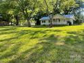 Quaint single-story home with a well-manicured lawn and mature trees providing shade and curb appeal at , Salisbury, NC 28147