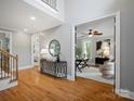 Welcoming foyer with hardwood floors, a staircase, and an open view to a sunlit office at 1030 Westbury Dr, Matthews, NC 28104