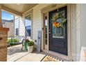 A welcoming front porch features a decorated door, bench, and potted plants for added curb appeal at 106 Sweet Briar Dr, Fort Mill, SC 29707