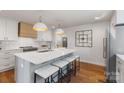Spacious kitchen showcasing a large central island, stainless steel appliances, and pendant lighting at 1314 Ordermore Ave, Charlotte, NC 28203