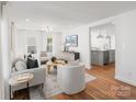 Open-concept living room flows into the kitchen, showcasing modern design at 1314 Ordermore Ave, Charlotte, NC 28203