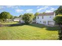 Spacious fenced backyard with lush green grass and mature trees, great for outdoor activities at 14311 Riding Hill Ave, Charlotte, NC 28213