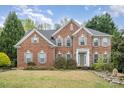 Charming brick two-story home with manicured lawn, symmetrical design and welcoming entrance at 2620 Shady Reach Ln, Charlotte, NC 28214