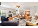 Inviting living room showcasing a fireplace, ceiling fan, natural light and an open floor plan at 2620 Shady Reach Ln, Charlotte, NC 28214
