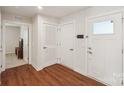Bright foyer featuring hardwood flooring, white walls, and storage at 4205 Jones Creek Ln, Charlotte, NC 28215