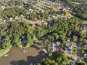 Gorgeous community aerial showcasing homes nestled amongst trees, with waterfront properties and stunning lake views at 444 Snapdragon Dr, Clover, SC 29710