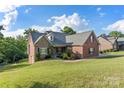 Charming two-story home with a combination of brick and stone exterior, set on a well-manicured lawn at 444 Snapdragon Dr, Clover, SC 29710