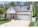 Charming home featuring a two-car garage, well-manicured lawn, and a inviting front porch at 4902 Looking Glass Trl, Denver, NC 28037