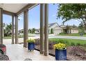 Covered porch framed by columns with colorful flower pots adds charm and curb appeal at 4902 Looking Glass Trl, Denver, NC 28037
