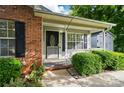 Inviting front porch with brick and siding, complemented by lush greenery at 519 Jacobs Rdg, Fort Mill, SC 29715