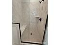 Bathroom shower featuring a built-in bench, rain shower head, and patterned herringbone tile at 6009 Countess Dr # 50, Charlotte, NC 28217