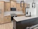 Kitchen features stainless steel appliances, an island with seating, and light wood cabinets at 6009 Countess Dr # 50, Charlotte, NC 28217