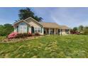 Inviting single-story home with green shutters and lush landscaping in the front yard at 6454 Sain Milling Rd, Vale, NC 28168