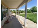 Covered front porch with rocking chairs, perfect for enjoying the outdoor scenery at 6454 Sain Milling Rd, Vale, NC 28168