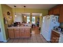 Bright kitchen featuring tile flooring, cabinets, and seamless access to the dining area at 6454 Sain Milling Rd, Vale, NC 28168