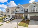Beautiful townhome exterior showcasing attached garages, driveway, and manicured landscaping at 8107 Houser St, Cornelius, NC 28031