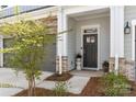Inviting front porch with decorative columns, stone accents, and a charming entrance at 8107 Houser St, Cornelius, NC 28031