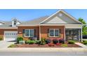 Well maintained brick home featuring manicured landscaping and a screened-in porch at 8473 Bing Cherry Dr, Denver, NC 28037