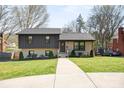 Beautifully updated home with a brick and dark gray exterior and a well-kept front yard at 1628 Starbrook Dr, Charlotte, NC 28210