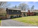 Lovely two-story home featuring a modern exterior and a green, grassy lawn at 1628 Starbrook Dr, Charlotte, NC 28210