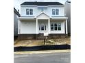 Charming two-story home with a covered front porch and classic architectural details at 19028 Newburg Hill Rd, Davidson, NC 28036