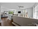 Bright open-concept living space with hardwood floors, comfortable seating, and a stylish kitchen island at 2100 Shadyview Dr, Charlotte, NC 28210