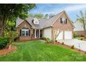 Lovely brick home features a two-car garage, lush lawn, and inviting facade, blending comfort and sophistication at 2478 23Rd Ne St, Hickory, NC 28601