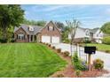Inviting brick home with a two-car garage, green lawn, and charming mailbox, showcasing suburban charm at 2478 23Rd Ne St, Hickory, NC 28601