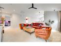 Comfortable living room featuring stylish seating, a ceiling fan, and an open layout at 2810 Berry Creek Rd, Charlotte, NC 28214