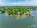 Lakefront property featuring lush greenery, several docks, and stunning water views on a clear, sunny day at 5200 Masons Ferry Rd, Clover, SC 29710