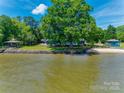Waterfront property featuring a gazebo, expansive lawn, and direct access to the water, perfect for outdoor enjoyment at 5200 Masons Ferry Rd, Clover, SC 29710