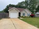 Charming single story home with a well maintained front yard and garage; perfect for suburban living at 5804 Crosswinds Ct, Indian Trail, NC 28079