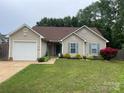 Lovely one-story house with a well-kept lawn, light siding, and a convenient attached garage for easy access at 5804 Crosswinds Ct, Indian Trail, NC 28079
