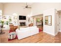 Bright living room with vaulted ceilings, hardwood floors, built-in shelving, and a cozy fireplace at 6425 High Creek Ct, Charlotte, NC 28277
