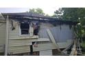 Severe fire damage to the side of the home, with charred siding and debris visible at 721 S Spruce St, Rock Hill, SC 29730