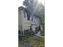 Shows significant fire damage to the side of the house, with damaged siding at 721 S Spruce St, Rock Hill, SC 29730