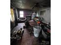 Damaged living room interior displaying debris, damaged walls, and a non-functional fireplace at 721 S Spruce St, Rock Hill, SC 29730